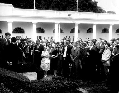 President John F. Kennedy greets the first group of Peace Corps Volunteers going to Tanganyika and Ghana, in the White House Rose Garden - JFKWHP-AR6760-B(1961) photo