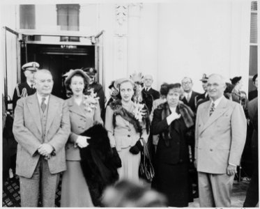 President and Mrs. Harry S. Truman, Alben W. Barkley, Mrs. Max Truitt, and Margaret Truman posing together, with... - NARA - 199939 photo