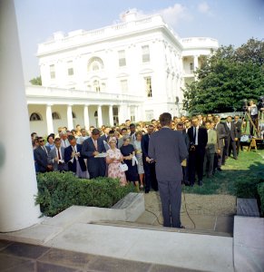 President John F. Kennedy greets the first group of Peace Corps Volunteers going to Tanganyika and Ghana, in the White House Rose Garden - KN-C18661-C photo