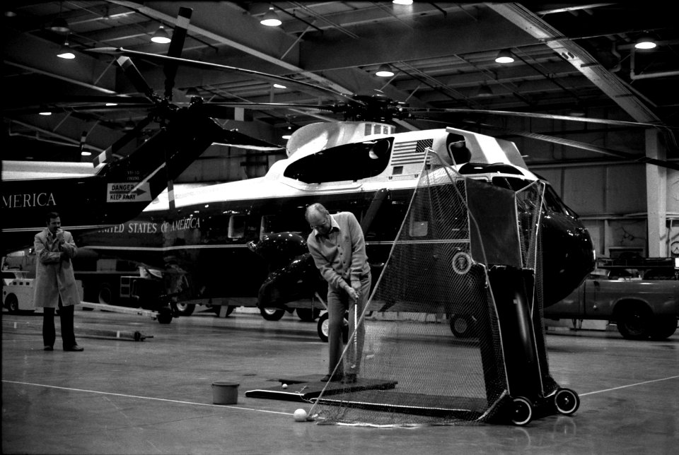 President Gerald Ford keeps in golf shape during a practice session in the Marine One Hangar