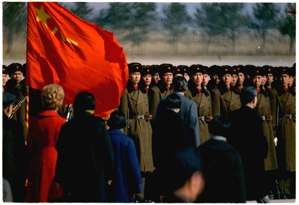 President and Mrs. Nixon's arrival in Peking, China. Nixon reviewing troops at the airport. - NARA - 194414