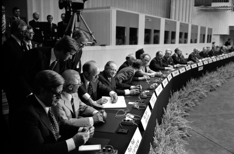 President Gerald Ford signs the Final Act of the Conference on Security and Cooperation in Europe