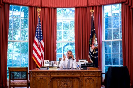 President Barack Obama talks on the phone with Cuba President Raúl Castro in the Oval Office, Sept. 18, 2015 photo