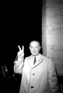 President Lyndon B. Johnson gives the victory sign