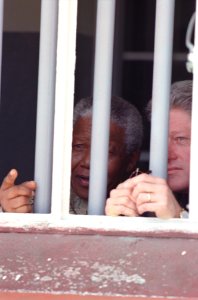 President Bill Clinton and President Nelson Mandela view Cell Block B where President Mandela was imprisoned photo