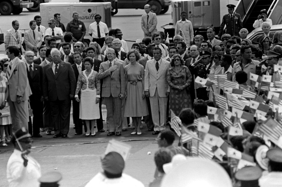 President Lakas, President Jimmy Carter, and General Omar Torrijos stand during the playing of the American national anthem at Tocumen Airport