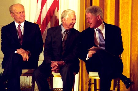 President Bill Clinton talks with former President Jimmy Carter as former President Gerald Ford looks on, at a China trade event photo