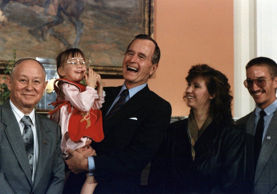 President Bush holds Jessica McClure during the Midland Community Spirit Award Presentation in the Roosevelt Room at... - NARA - 186402