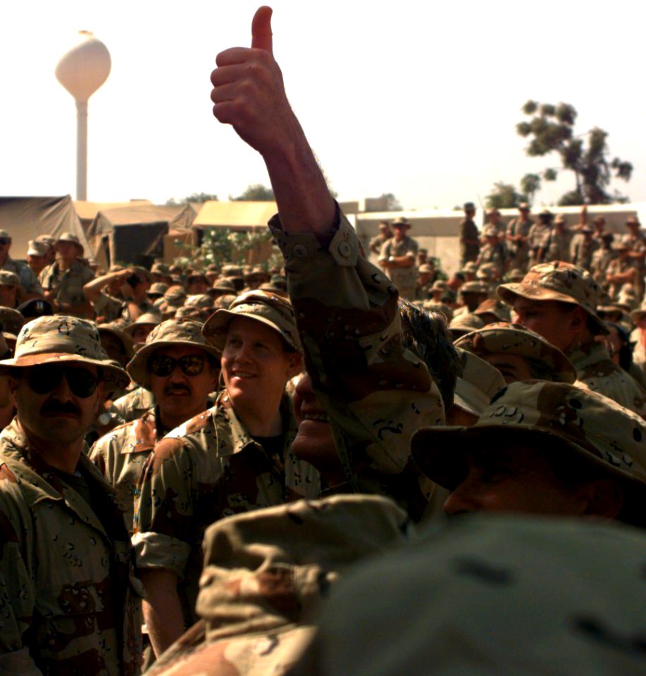 President George H. W. Bush gives the thumbs up sign to the troops upon his arrival at the American Embassy Compound