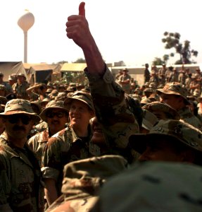 President George H. W. Bush gives the thumbs up sign to the troops upon his arrival at the American Embassy Compound