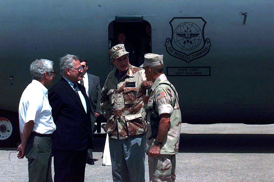 President George H. W. Bush is escorted from a US Air Force C-141 Starlifter