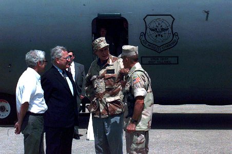 President George H. W. Bush is escorted from a US Air Force C-141 Starlifter