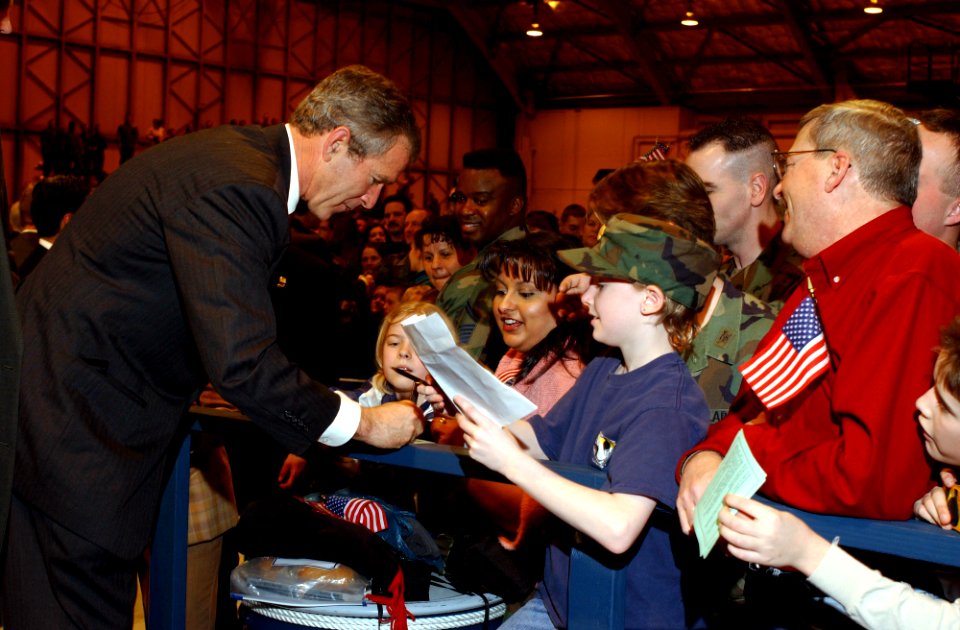President George W. Bush signs autographs at Elmendorf Air Force Base