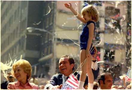 President Richard Nixon and Pat Nixon Stand and Wave to a crowd in Atlanta, Georgia during a Motorcade and President Nixon Steadies a Child Majorette photo