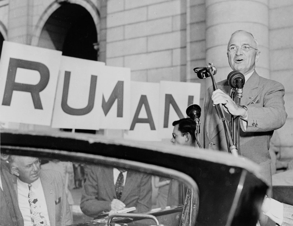 President Harry S. Truman standing in an open car, speaking into microphones, Washington, DC. President Truman had... - NARA - 199965 (cropped)