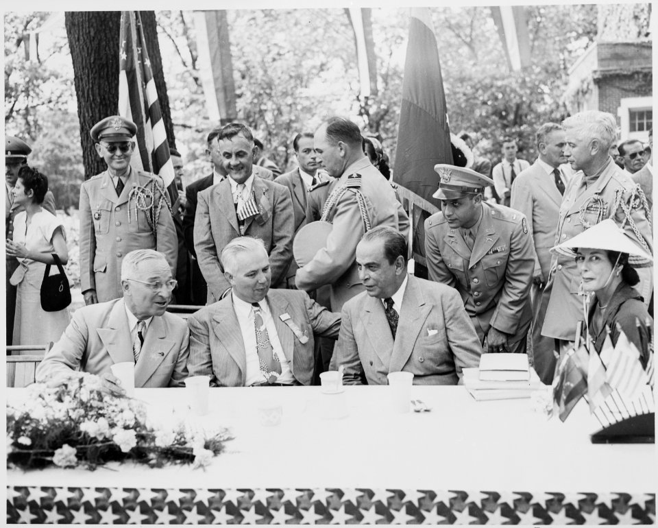 President Harry S. Truman, President Romulo Gallegos of Venezuela, and an unidentified man seated at a table, engaged... - NARA - 199924