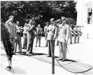 President Romulo Gallegos of Venezuela visits Arlington National Cemetery. In this photo he has just placed a wreath... - NARA - 199831