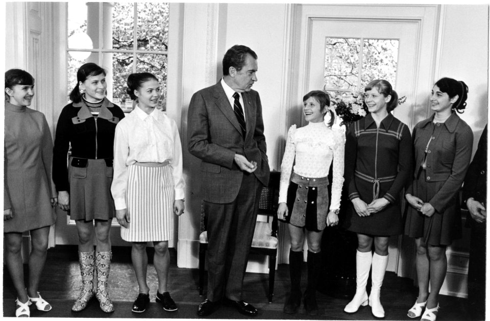 President Richard Nixon standing in the Oval Office with members of the Russian Soviet Women's Gymnastics Team