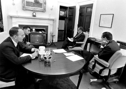 President Richard Nixon, Michael Collins, William Anders, and Henry Kissinger watch the Apollo 13 Command Module Odyssey Splash Down on Television