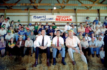 President Ronald Reagan and John Block Leon Wilkinson Sitting on Hay During Question and Answer Session