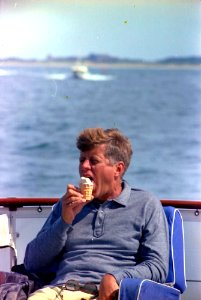 President John F. Kennedy eats ice cream aboard the Honey Fitz