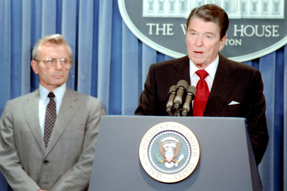 President Ronald Reagan and Frank Carlucci speaking at the podium making a statement to the press outlining United States Policy in the Persian Gulf in the Press Room