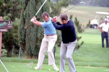 President Ronald Reagan and George H. W. Bush playing golf at Andrews Air Force Base