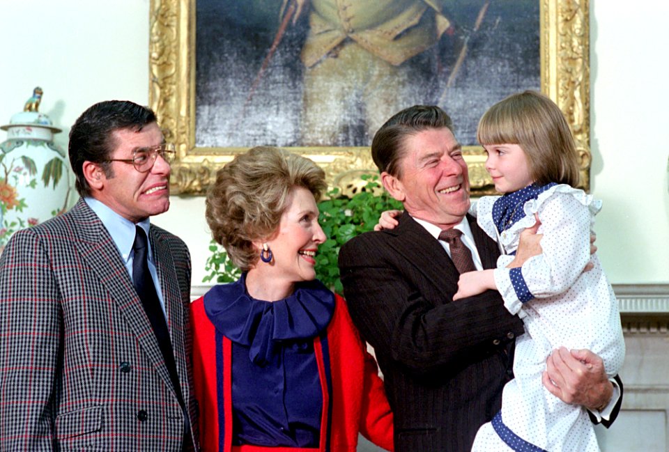 President Ronald Reagan and Nancy Reagan and Nancy Reagan meeting with Jerry Lewis and the Muscular Dystrophy poster child Christi Bartlett in the Oval Office