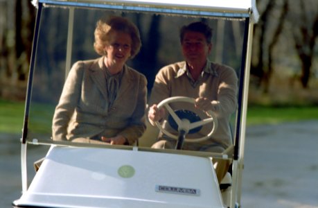 President Ronald Reagan and Prime Minister Margaret Thatcher of United Kingdom at Camp David driving golf cart to Aspen Lodge