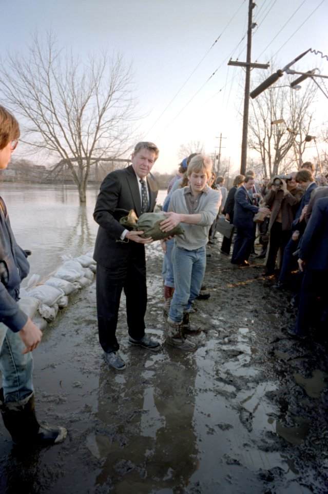 President Ronald Reagan helping place sandbags