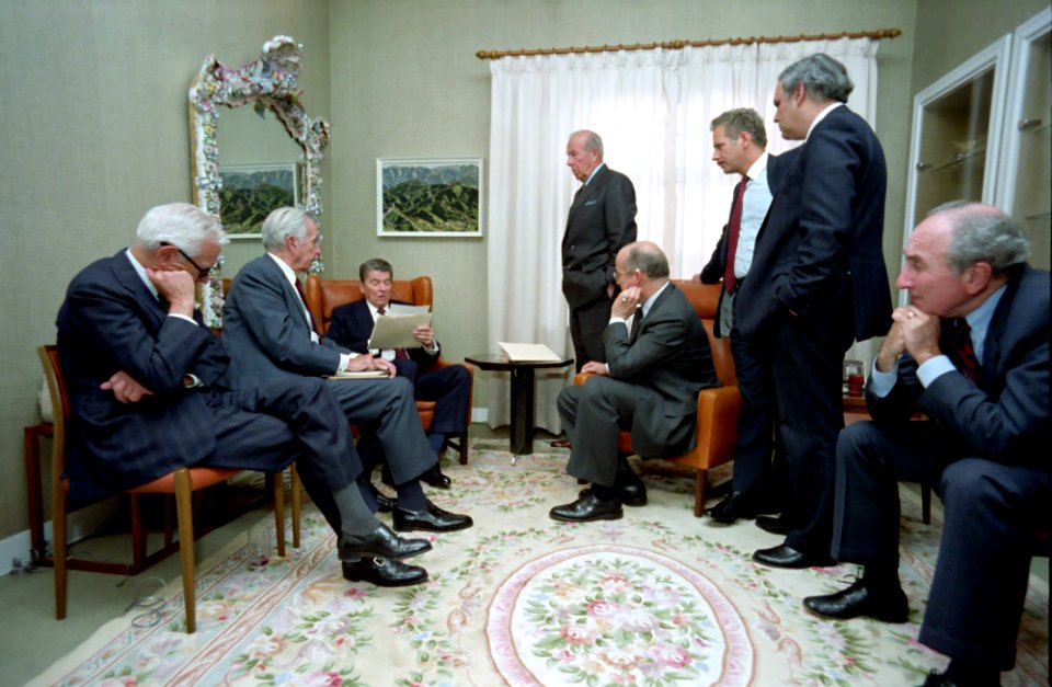 President Ronald Reagan in a staff briefing with Ken Adelman, George Shultz, Donald Regan, Paul Nitze, Max Kampelman, Richard Perle, and John Poindexter