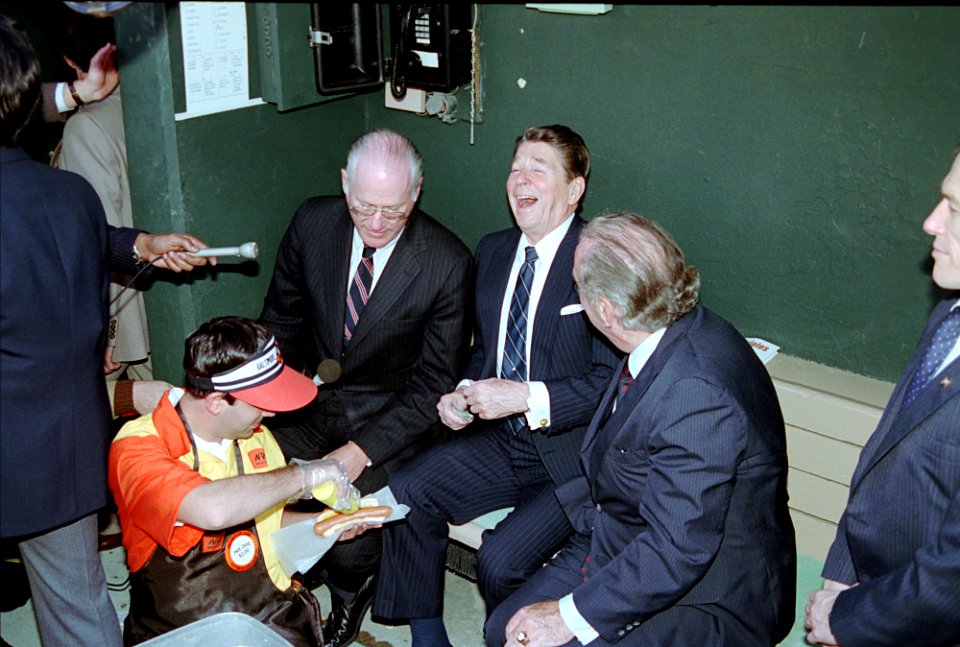 President Ronald Reagan in the dugout with Bowie Kuhn and Edward Bennett Williams while attending opening day game of 1984 Baseball Season at Memorial Stadium between the Baltimore Orioles and Chicago White Sox