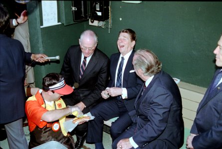 President Ronald Reagan in the dugout with Bowie Kuhn and Edward Bennett Williams while attending opening day game of 1984 Baseball Season at Memorial Stadium between the Baltimore Orioles and Chicago White Sox photo