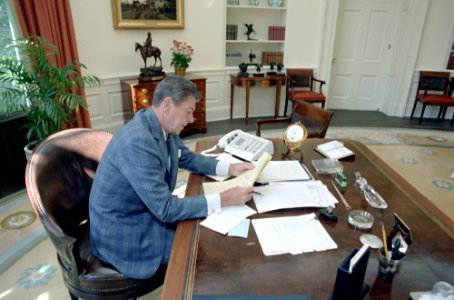 President Ronald Reagan in the Oval Office working on upcoming speech to the nation