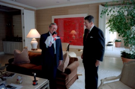 President Ronald Reagan looking at a puppet Howard Baker is holding in his Century Plaza Hotel suite photo