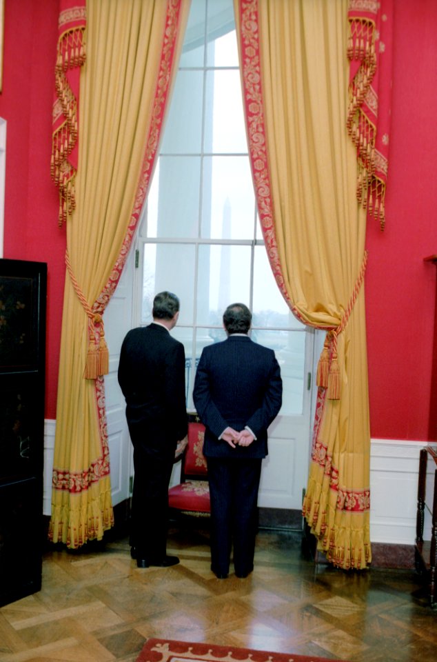 President Ronald Reagan looking out window in Red Room with Wilfried Martens