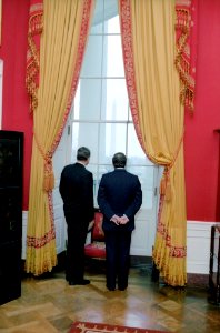 President Ronald Reagan looking out window in Red Room with Wilfried Martens
