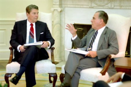 President Ronald Reagan meeting with Charles Wick in the Oval Office photo