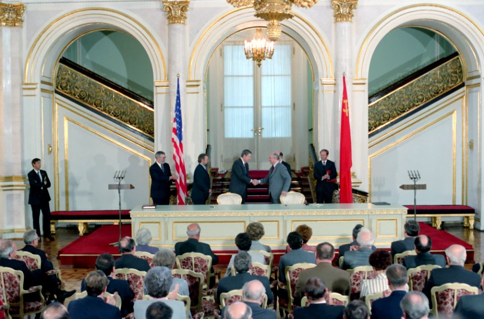 President Ronald Reagan and Mikhail Gorbachev shake hands at the signing ceremony for INF Treaty