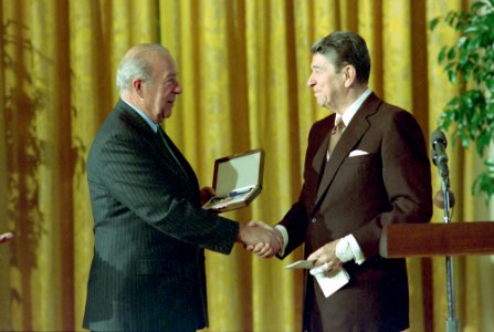 President Ronald Reagan presenting medal to George Shultz during the Medal of Freedom Luncheon in the East Room