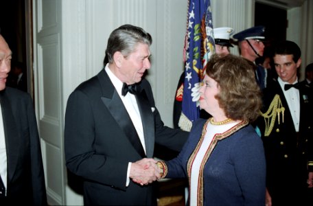 President Ronald Reagan shaking hands with Shirley Temple Black