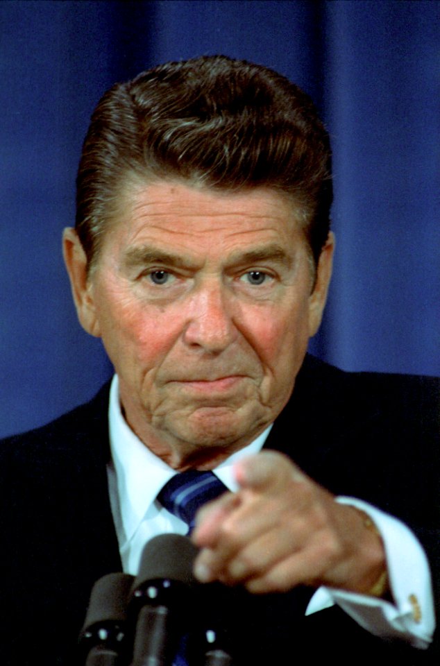 President Ronald Reagan motions to a reporter during a White House Press Conference in the East Room