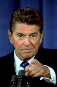 President Ronald Reagan motions to a reporter during a White House Press Conference in the East Room