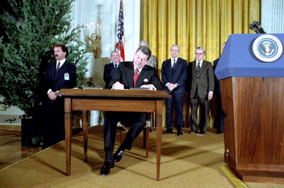 President Ronald Reagan signs Proclamations 5003 and 5004 to Commemorate Human Rights Week and First Anniversary of Martial Law in Poland in the East Room