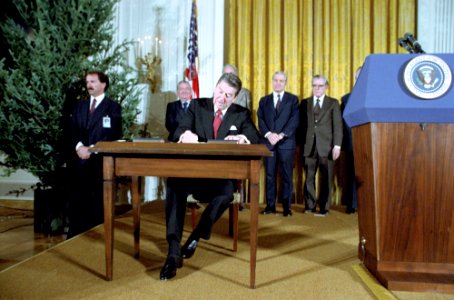 President Ronald Reagan signs Proclamations 5003 and 5004 to Commemorate Human Rights Week and First Anniversary of Martial Law in Poland in the East Room photo