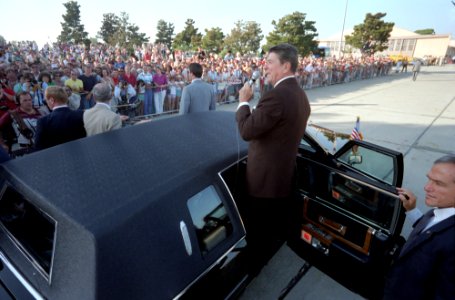 President Ronald Reagan speaking to the crowd from his limousine on a trip to California