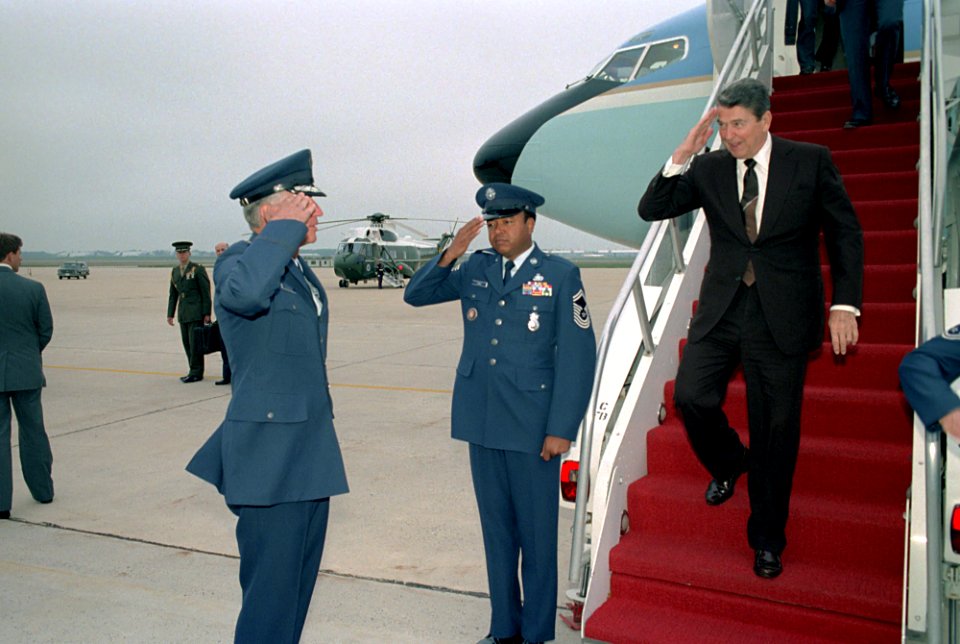 President Ronald Reagan saluting as he returns from a trip from Tennessee on Air Force One to Andrews Air Force Base