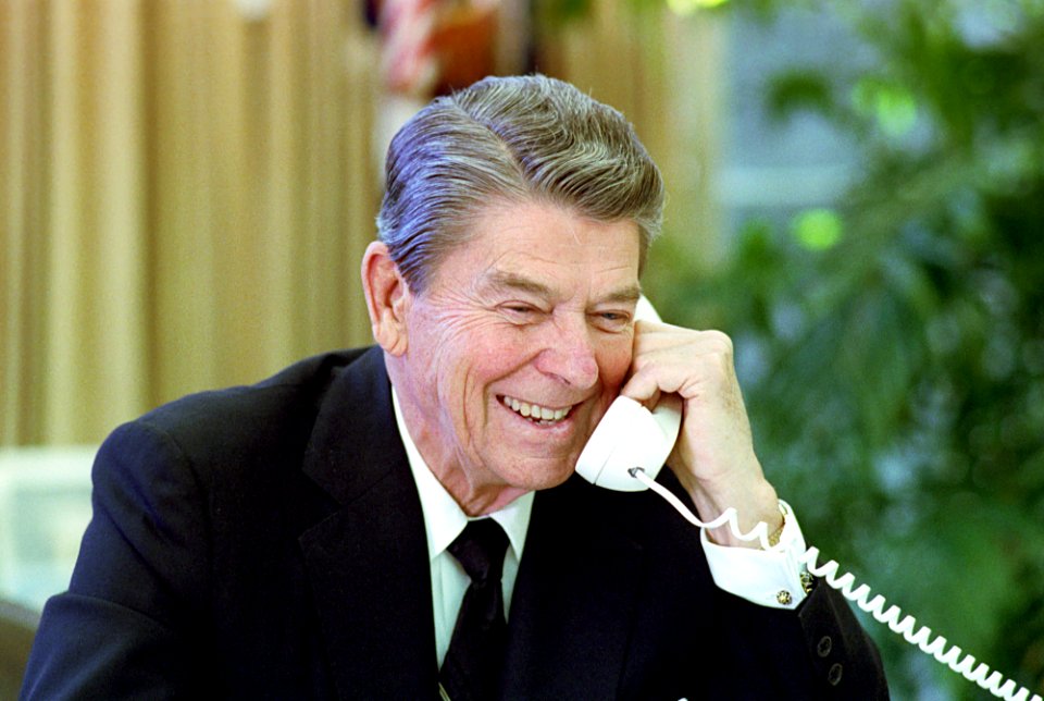 President Ronald Reagan talking on the telephone with Prime Minister Margaret Thatcher of the United Kingdom in the Oval Office