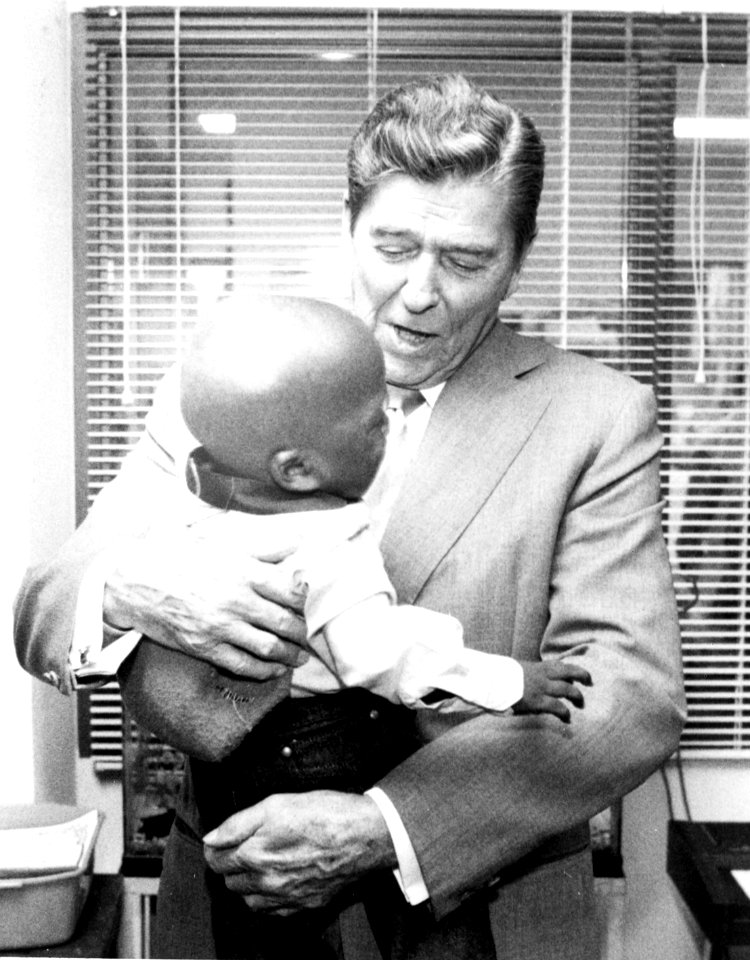 President Reagan at NIH with young patient (14172882837)