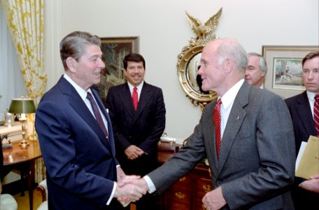 President Ronald Reagan shaking hands with John Glenn photo